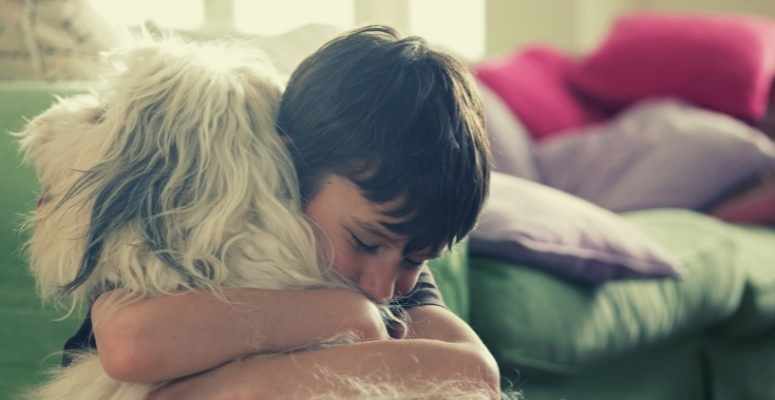 boy hugging dog